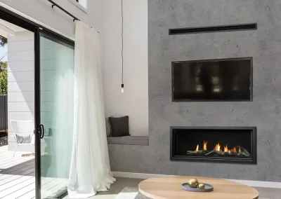 Modern living room with wall-mounted TV above sleek linear fireplace