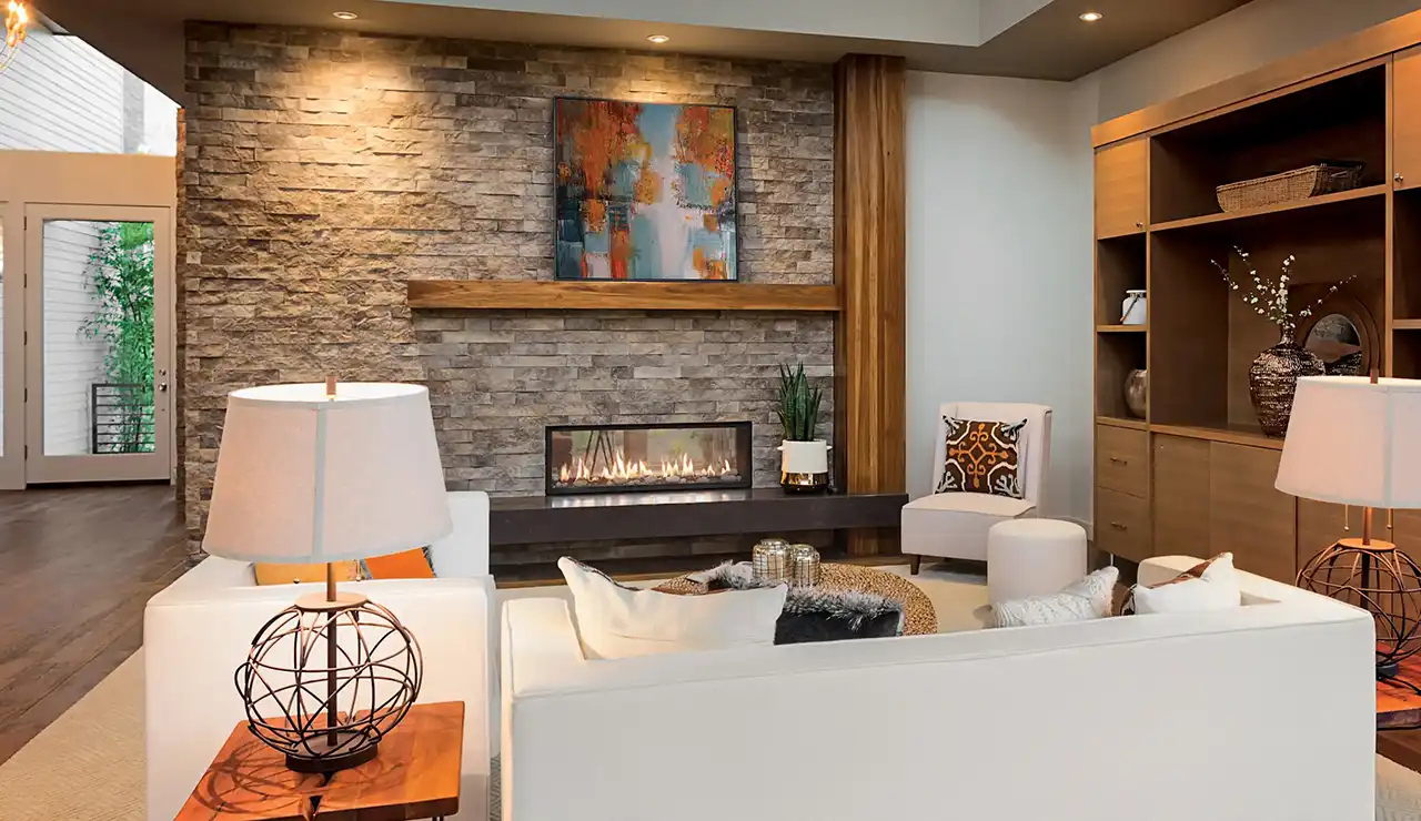 Modern living room with stone fireplace, wood accents, and cozy seating