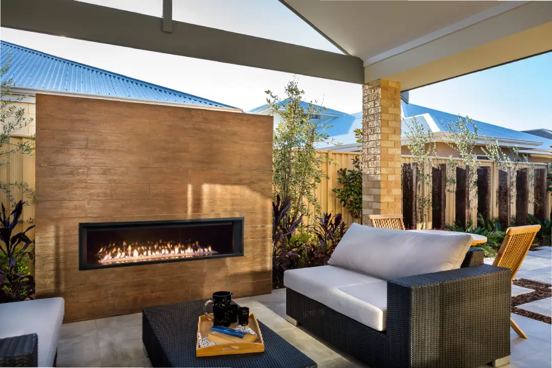 Modern outdoor patio with linear gas fireplace, wicker seating, and covered backyard entertainment area